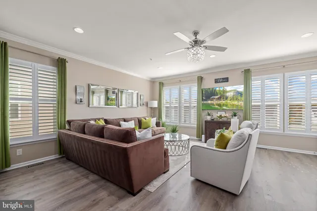 a view of a hallway with wooden floor and windows