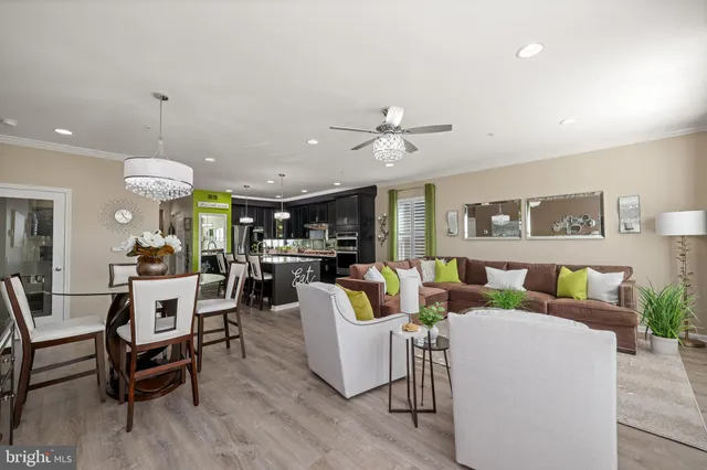 a kitchen with a dining table chairs and refrigerator