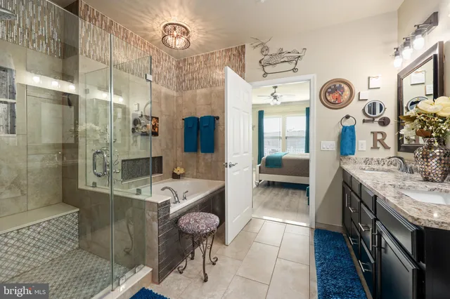 a bathroom with a granite countertop sink toilet and shower