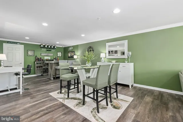 a view of a livingroom with dining area a chandelier and wooden floor