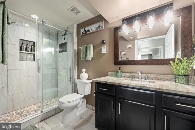 a view of a house with brick walls and a yard with plants