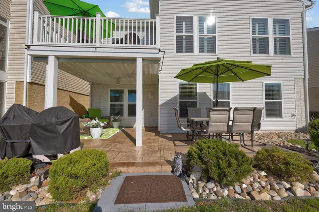 a front view of house with a garden and plants