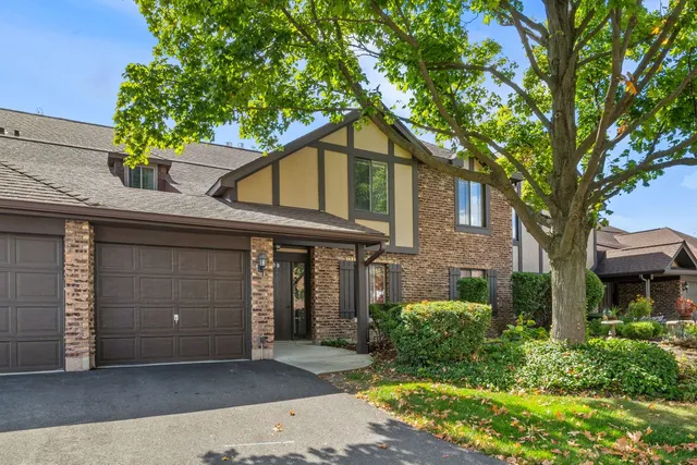 front view of a house with a tree