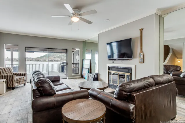 a living room with furniture a fireplace and a flat screen tv