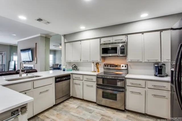 a kitchen with a sink stove and microwave