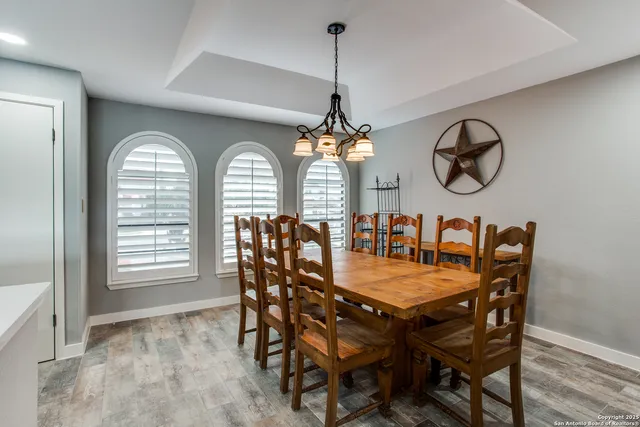 a view of a dining room with furniture and window