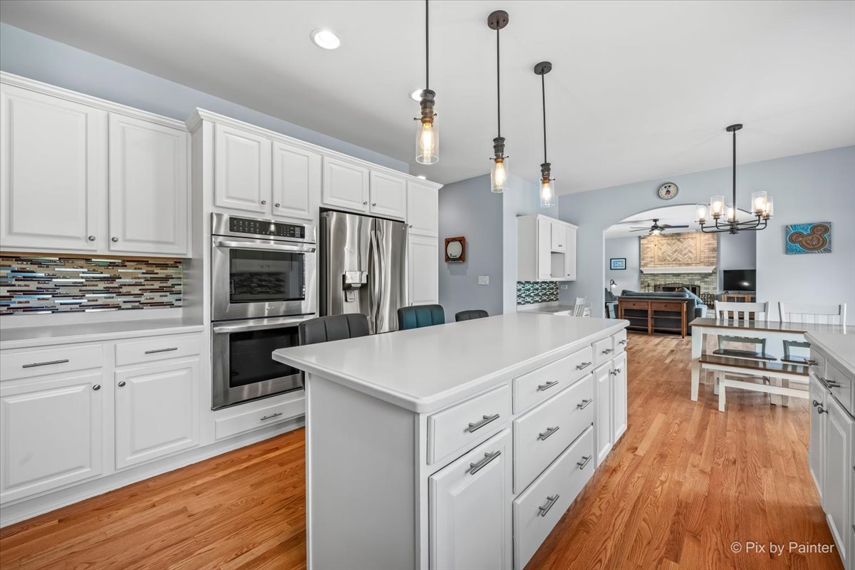 7104 Dove Way Cary, IL 60013 - Photo 22 of 82 a kitchen with white cabinets and stainless steel appliances