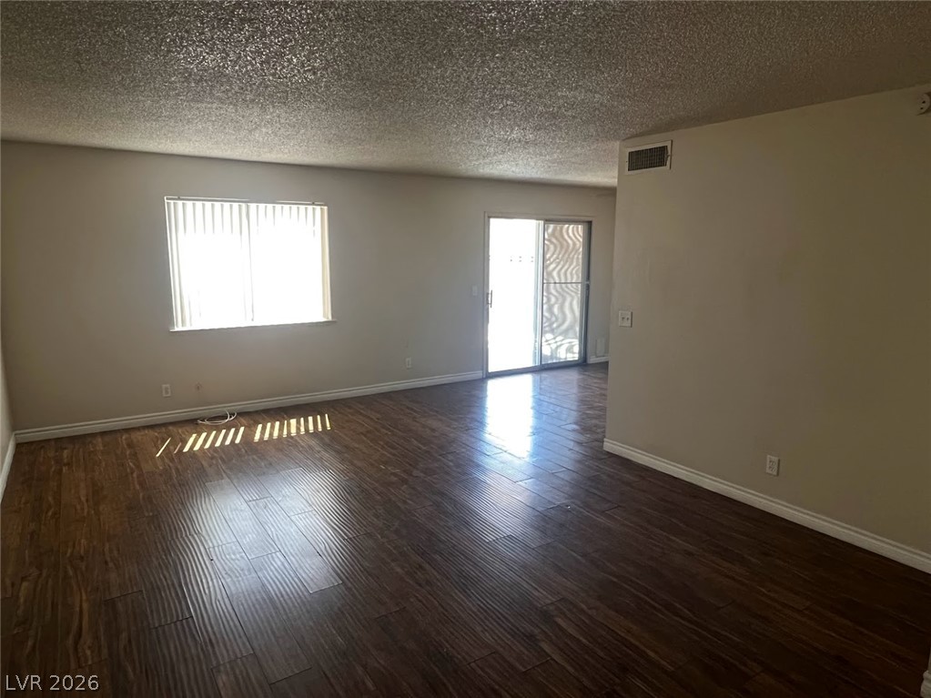 914 Scarlet Ridge Drive Las Vegas, NV 89128 - Photo 5 of 25 Rich hardwood-style flooring extends through this airy living space with sliding door access to outdoor areas.