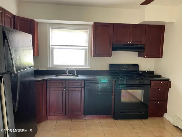 a kitchen with stainless steel appliances granite countertop a refrigerator and a stove
