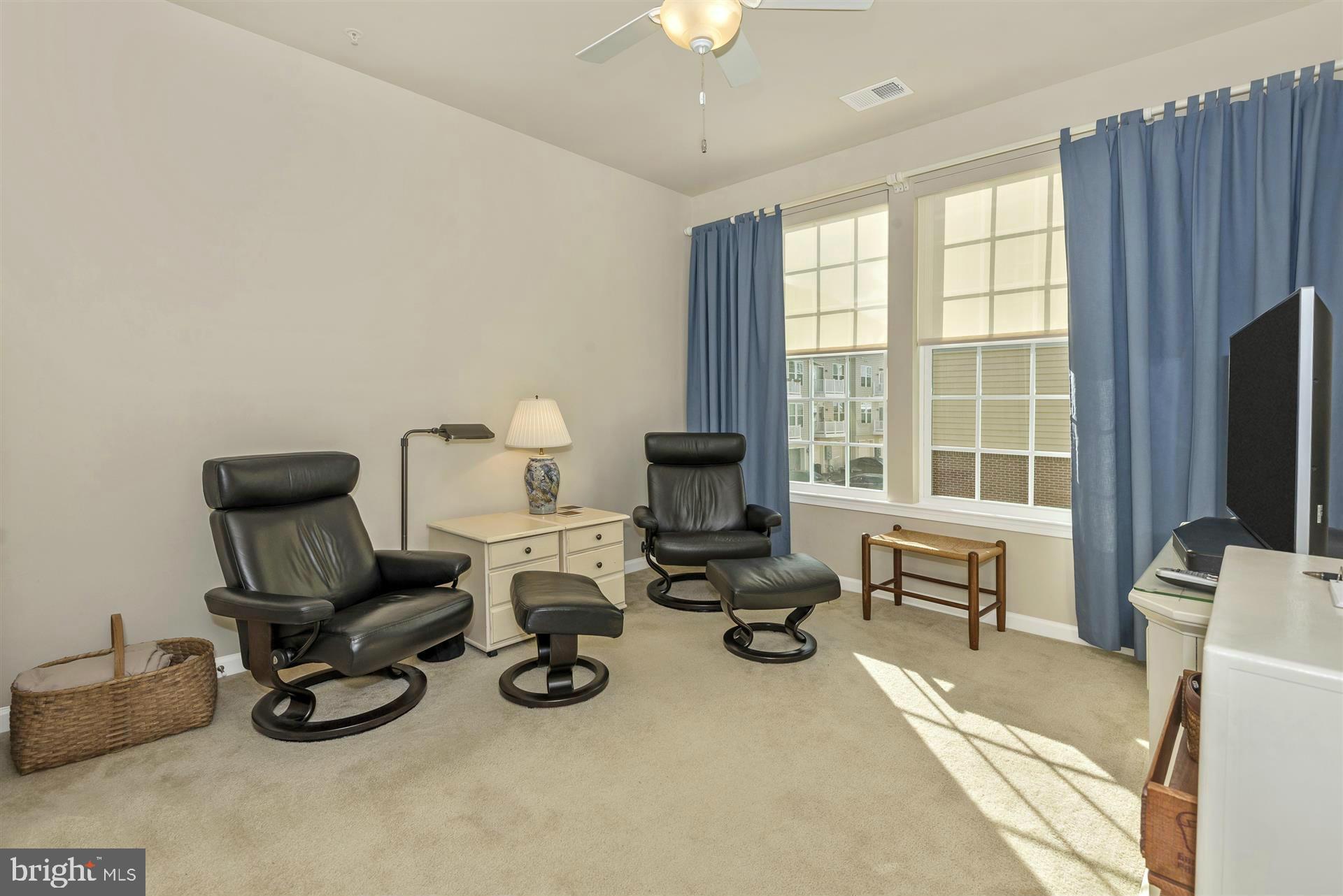212 Mill Pond Road, Unit A Frederick, MD 21701 - Photo 8 of 29 a room with furniture a large window and a flat screen tv