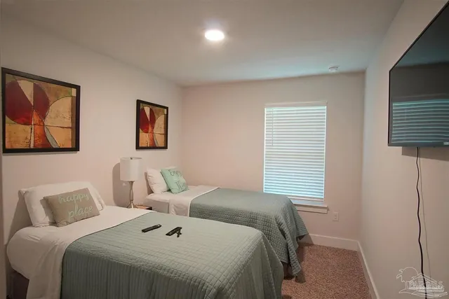 a bedroom with a bed and a night stand