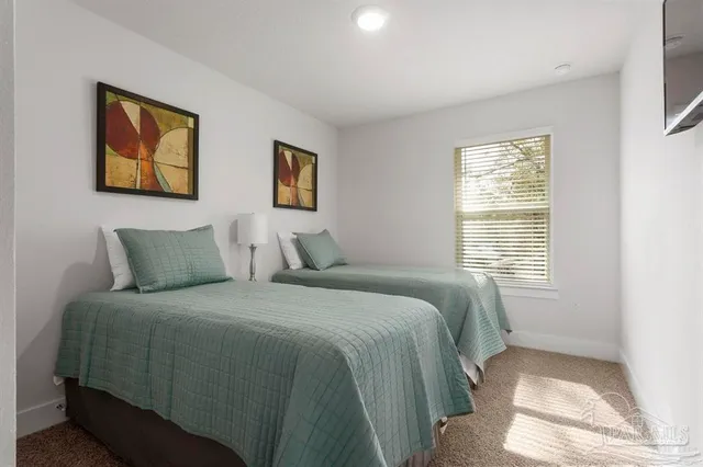 a bedroom with double bed and a window