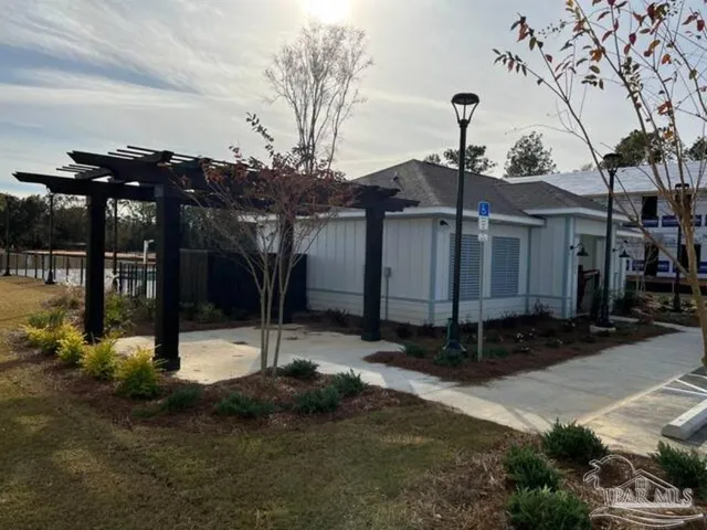 a view of swimming pool with lake and houses in the back
