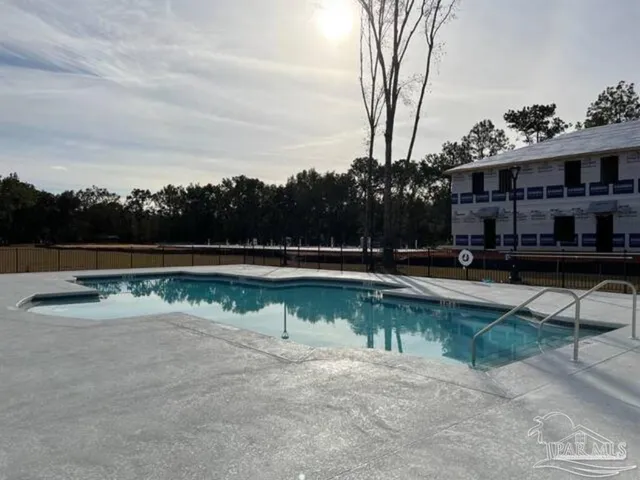 a view of swimming pool with outdoor seating