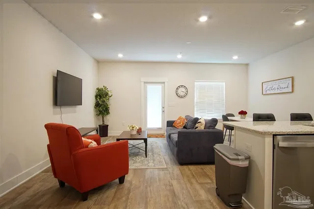 a living room with furniture and a flat screen tv