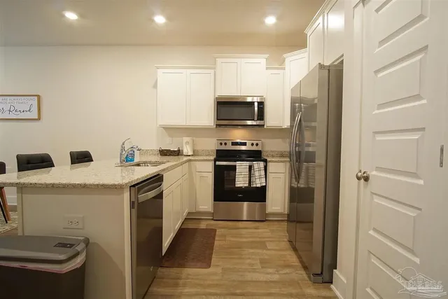 a kitchen with a sink a stove and refrigerator