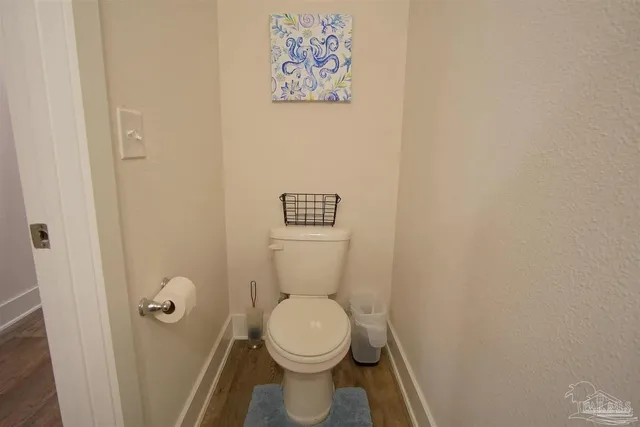 a white toilet sitting next to a shower