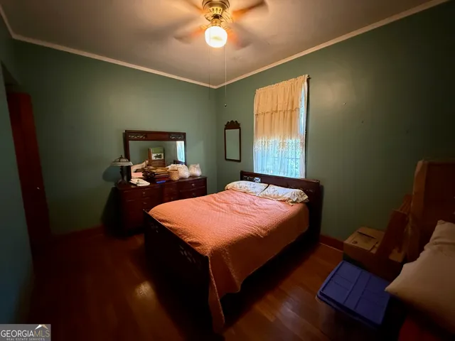 a bed sitting in a bedroom next to a window