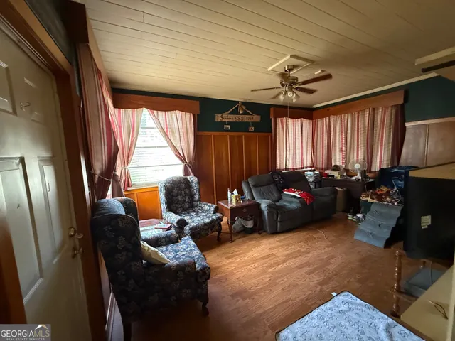 a view of a patio with table and chairs and potted plants