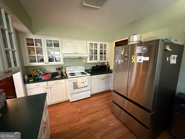 a kitchen with stainless steel appliances a refrigerator sink and cabinets