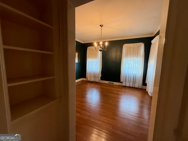 a view of a room with wooden floor