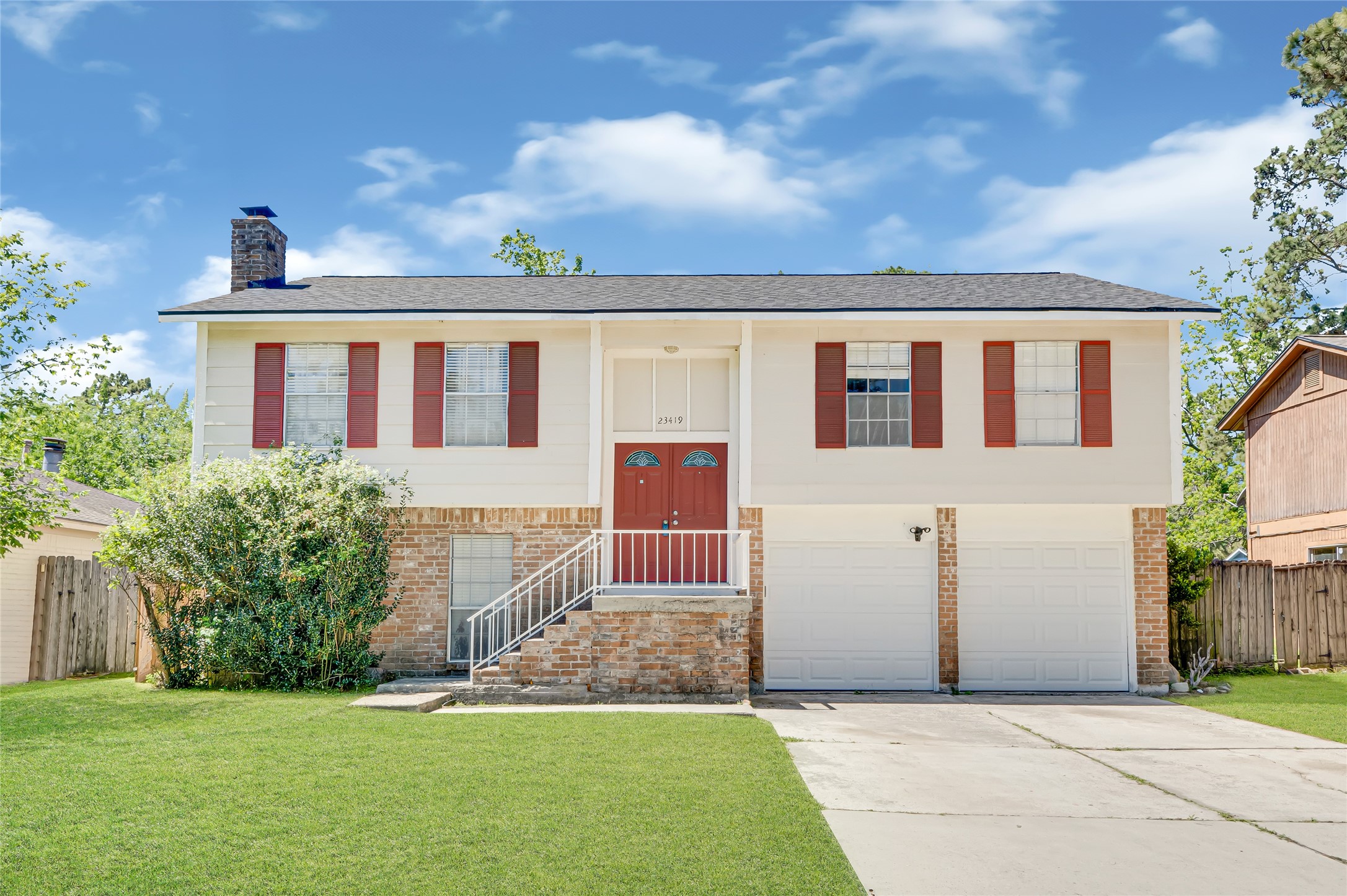 Front with double wide driveway and 2 car garage.