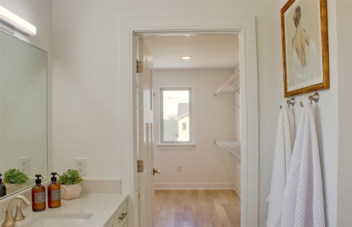 300 Tesla Circle Austin, TX 78681 - Photo 25 of 39 Bathroom with light wood finished floors and vanity