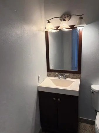 a bathroom with a sink and mirror
