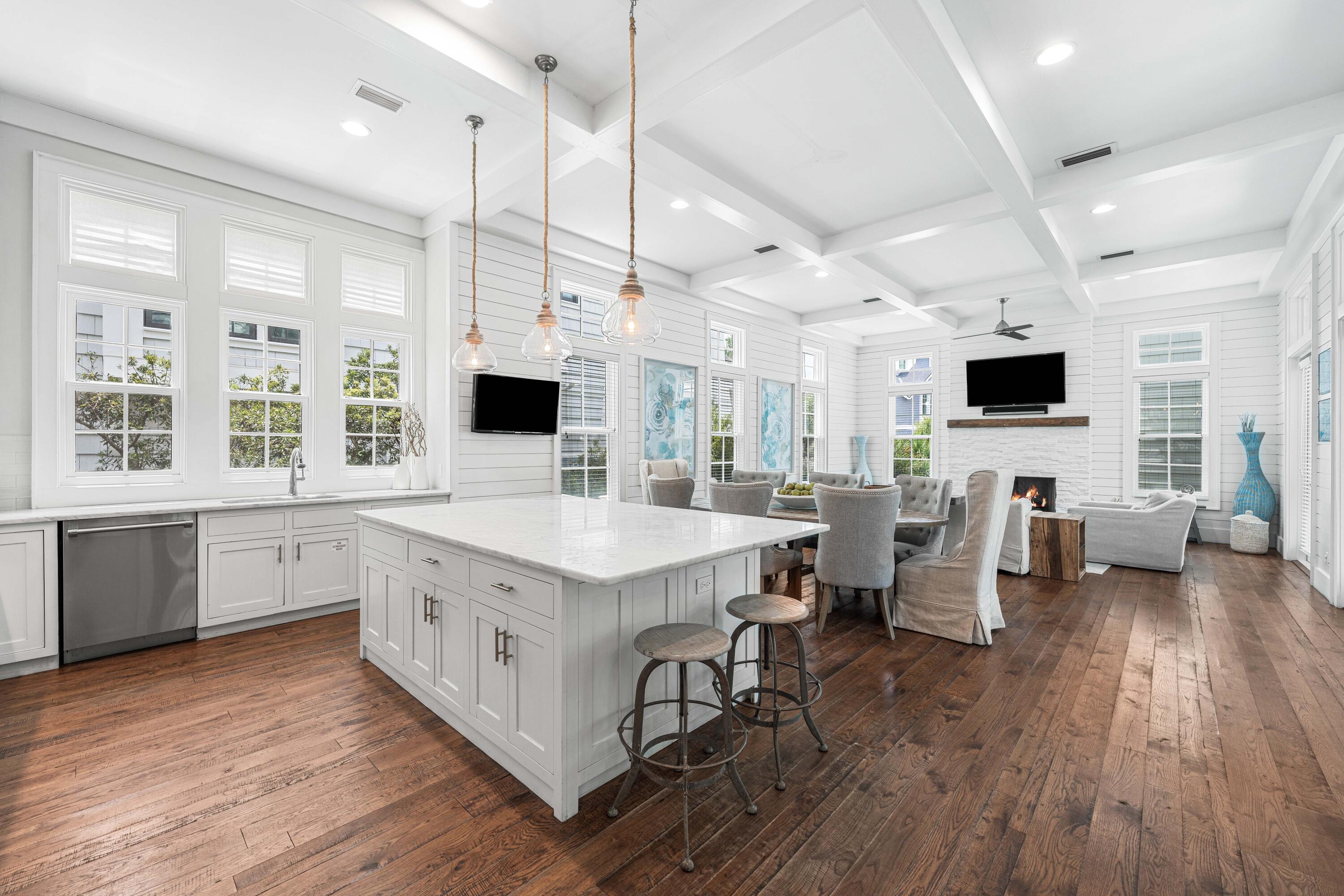 34 North Watch Tower Lane Inlet Beach, FL 32461 - Photo 14 of 90 a large kitchen with stainless steel appliances kitchen island granite countertop a stove a sink dishwasher a dining table and chairs with wooden floor