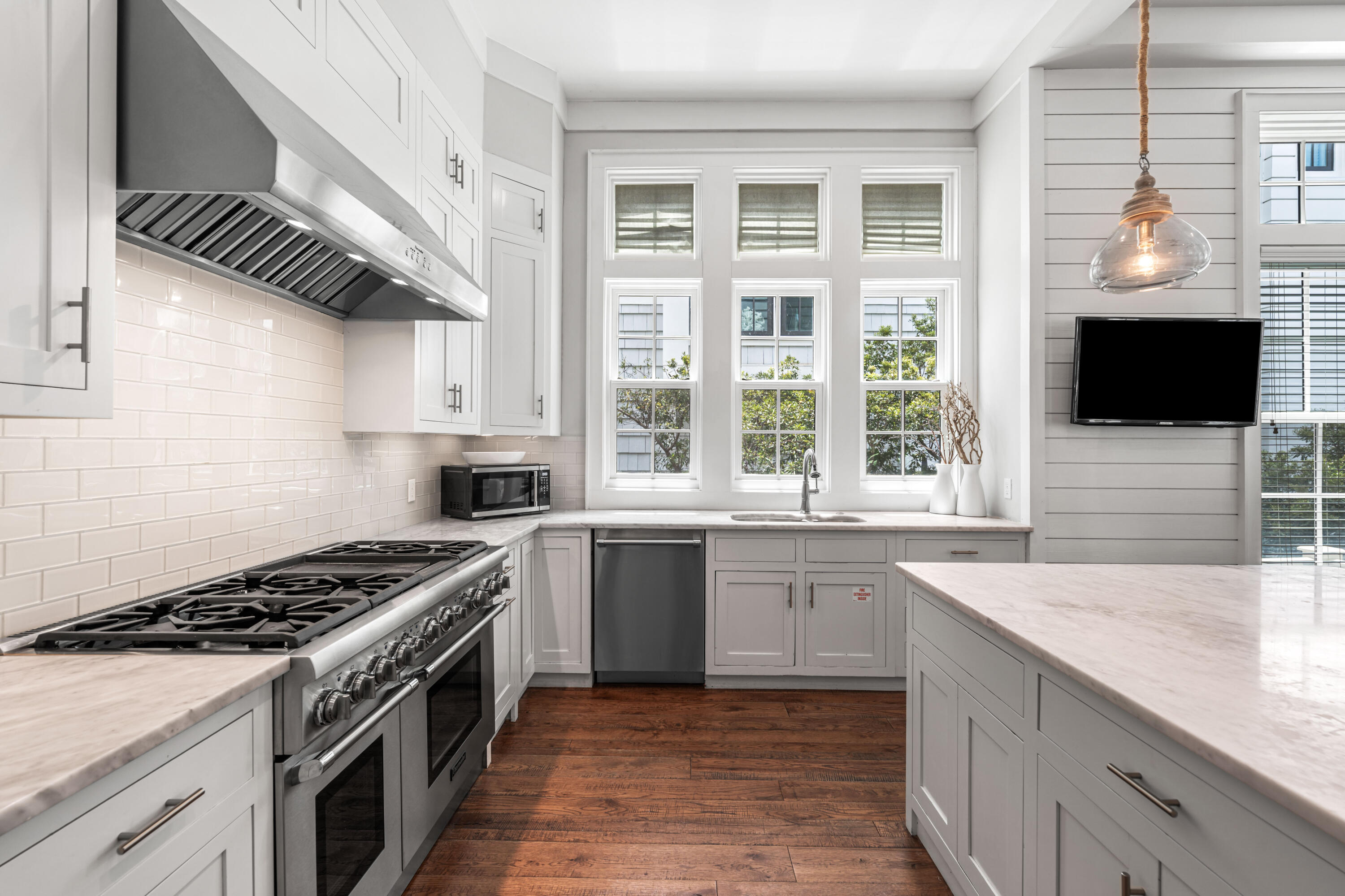 34 North Watch Tower Lane Inlet Beach, FL 32461 - Photo 15 of 90 a kitchen with stainless steel appliances granite countertop a sink a stove and a wooden cabinets