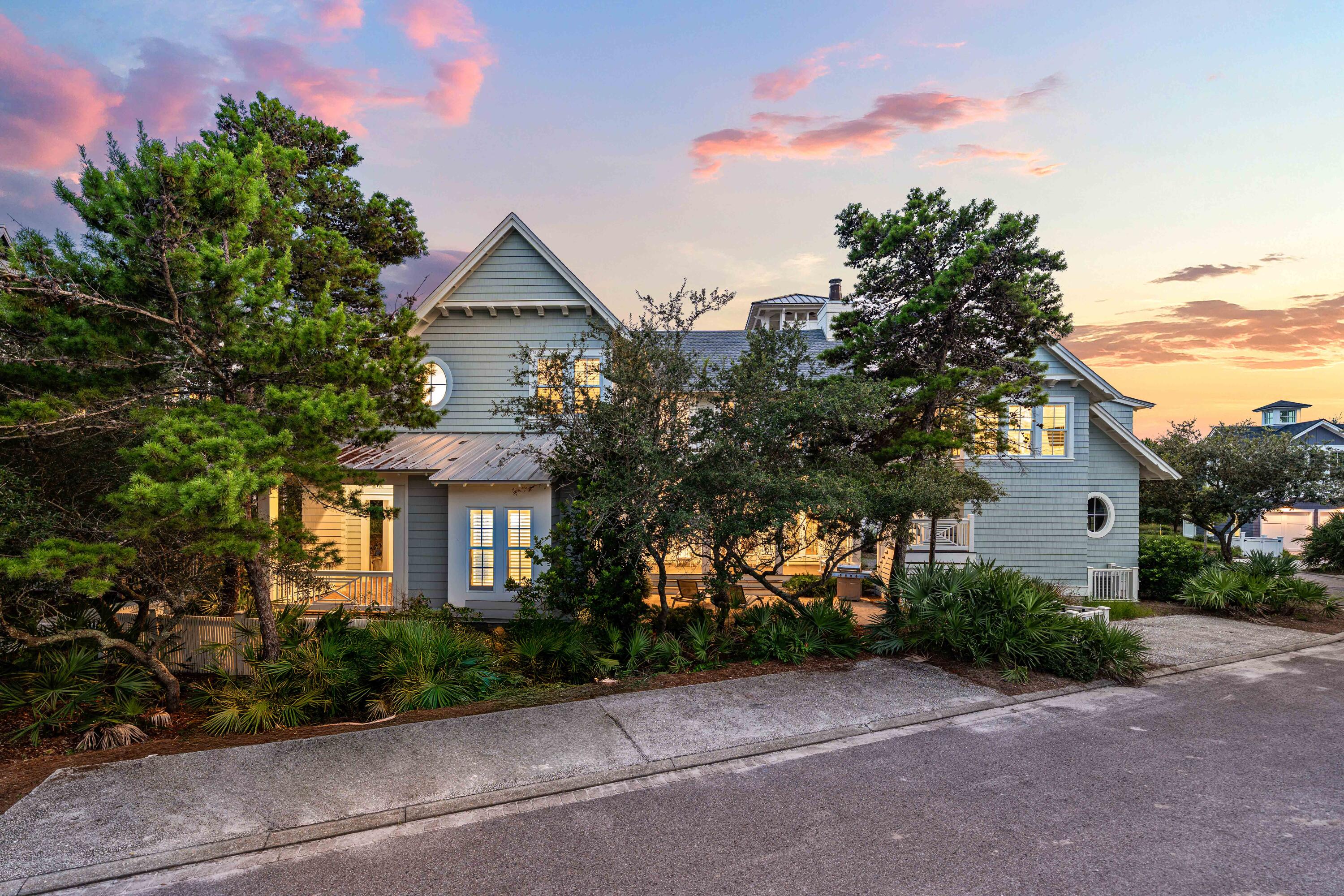 34 North Watch Tower Lane Inlet Beach, FL 32461 - Photo 4 of 90 a yellow house with trees in front of it