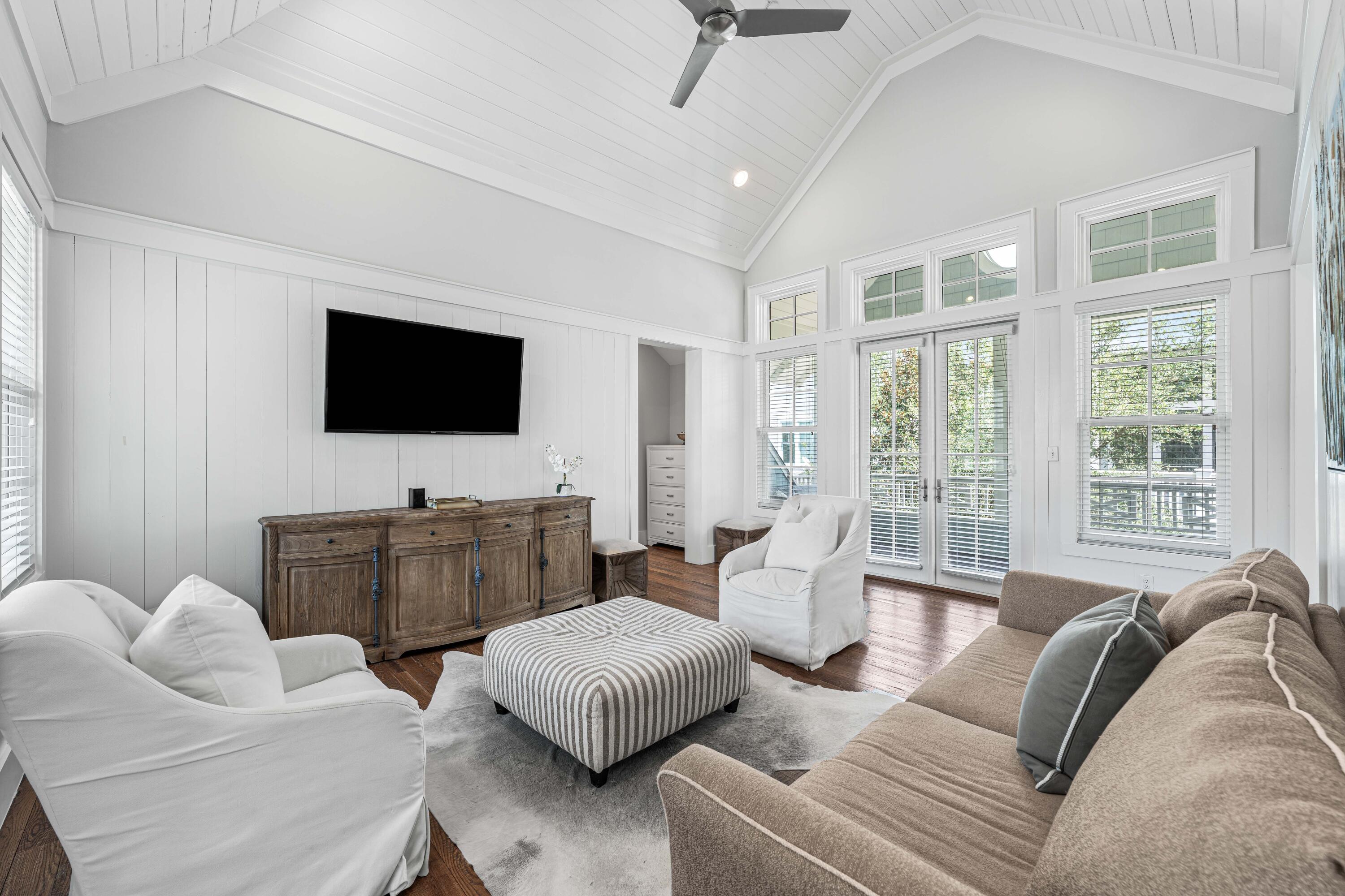 34 North Watch Tower Lane Inlet Beach, FL 32461 - Photo 43 of 90 a living room with furniture a flat screen tv and a large window