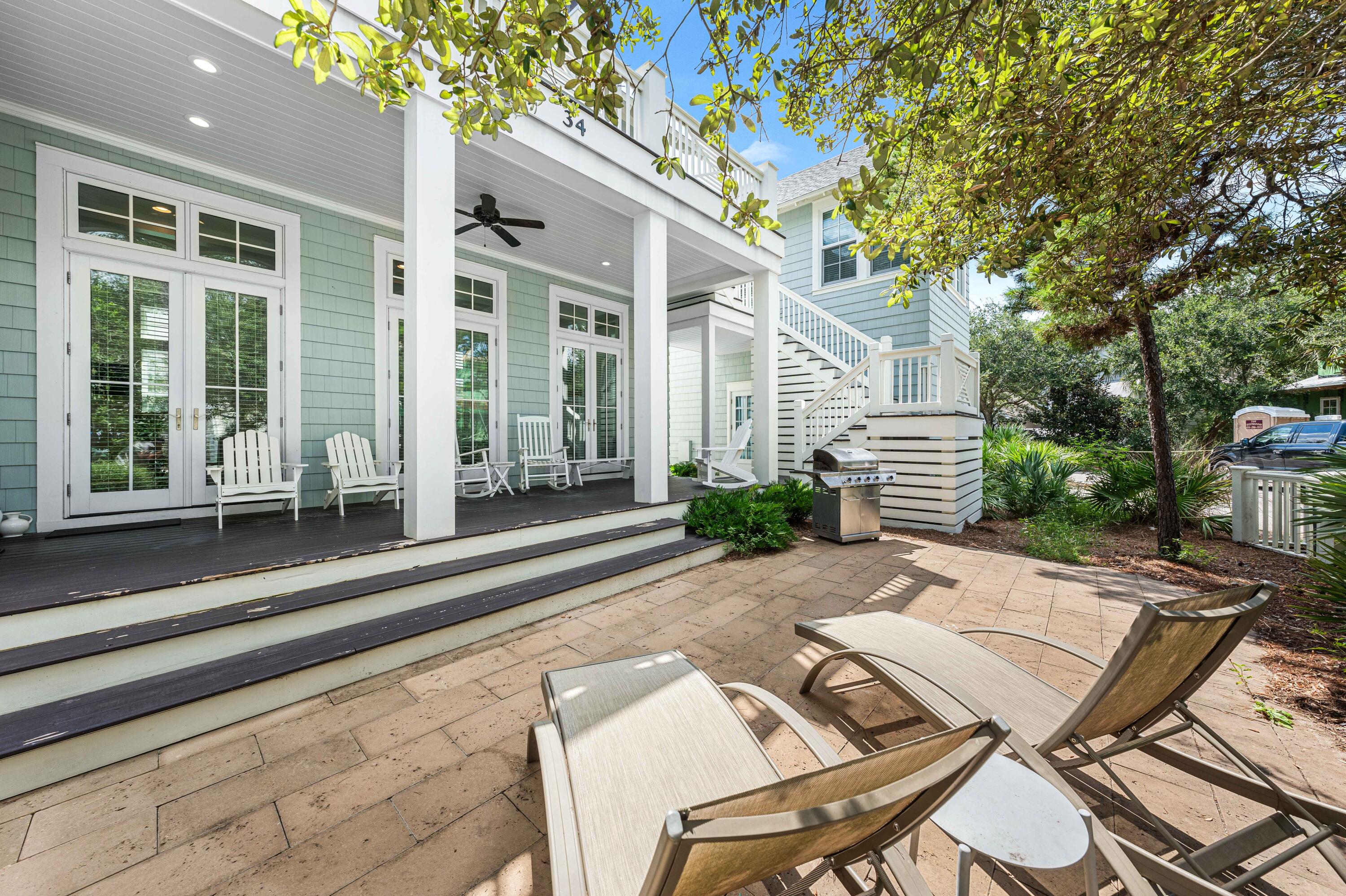 34 North Watch Tower Lane Inlet Beach, FL 32461 - Photo 69 of 90 a view of a patio with table and chairs and wooden fence