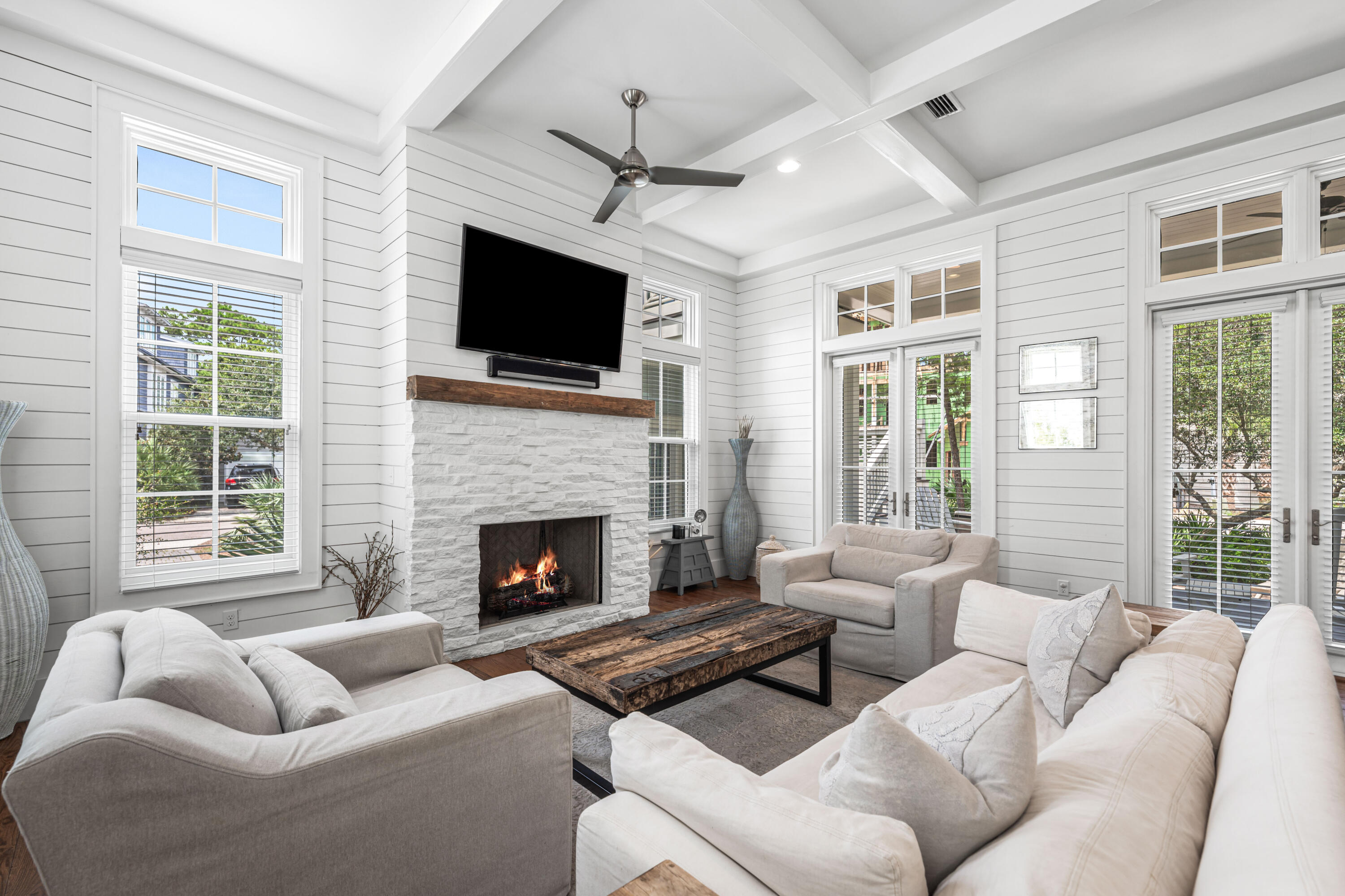 34 North Watch Tower Lane Inlet Beach, FL 32461 - Photo 9 of 90 a living room with furniture a flat screen tv and a fireplace