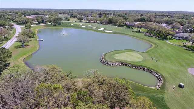 an aerial view of a house with a lake view