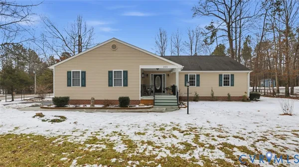 a view of a house with a yard covered in snow