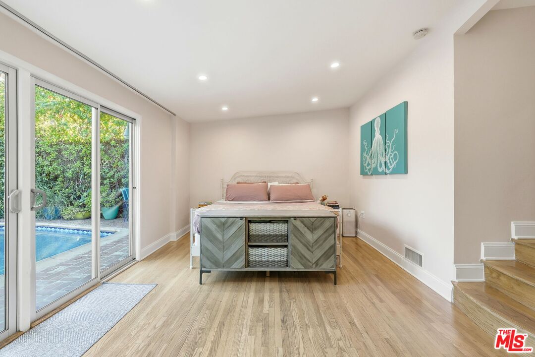 12420 Barbara Avenue Los Angeles, CA 90066 - Photo 17 of 40 a room with a bed and wooden floor