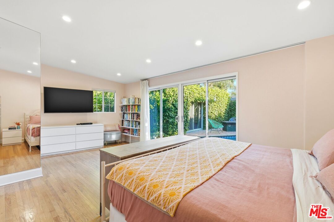 12420 Barbara Avenue Los Angeles, CA 90066 - Photo 18 of 40 a large bedroom with a large bed and a flat tv screen