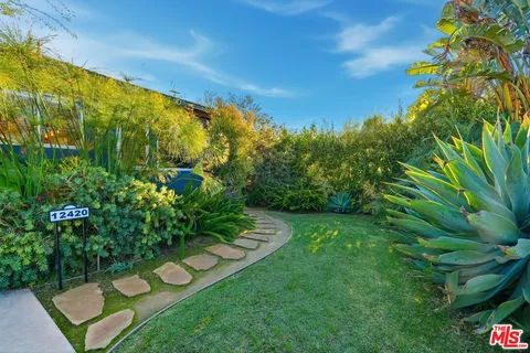 a view of a garden with an outdoor seating