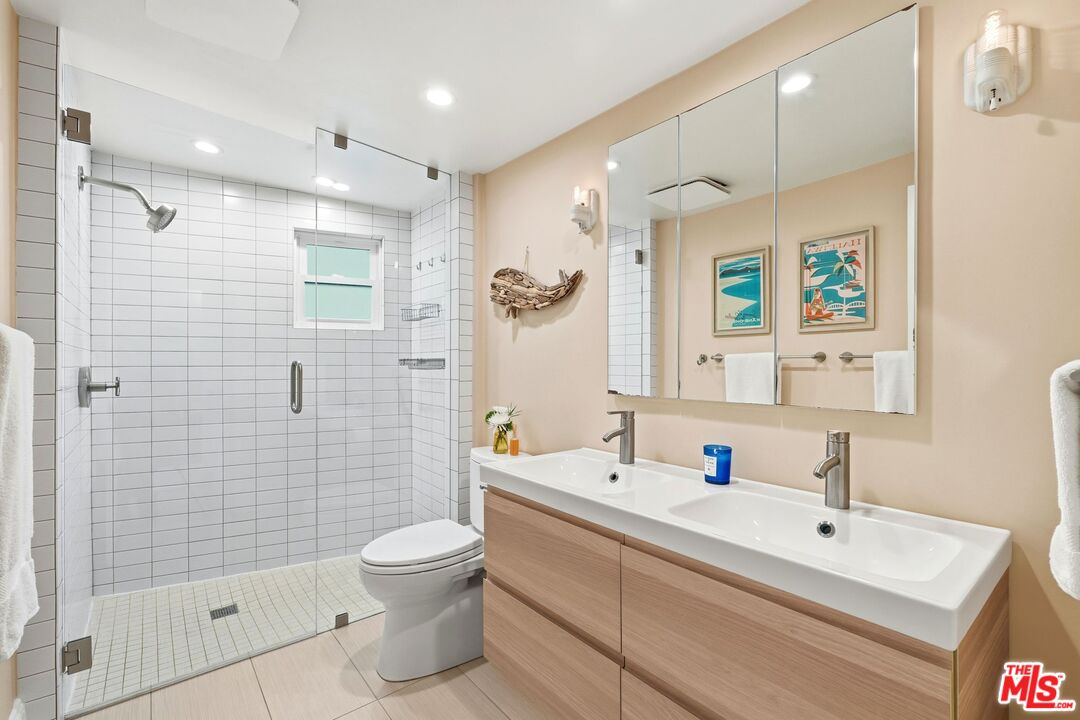 12420 Barbara Avenue Los Angeles, CA 90066 - Photo 21 of 40 a bathroom with a sink a toilet and shower