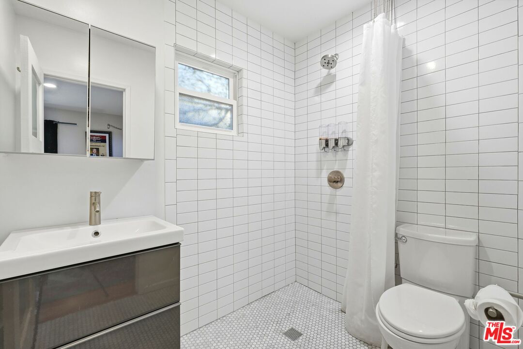 12420 Barbara Avenue Los Angeles, CA 90066 - Photo 28 of 40 a bathroom with a sink a toilet and shower