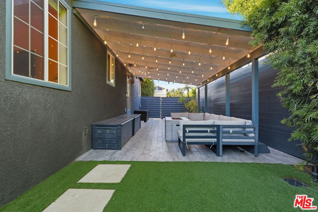 12420 Barbara Avenue Los Angeles, CA 90066 - Photo 34 of 40 a view of a patio with table and chairs with plants and wooden fence
