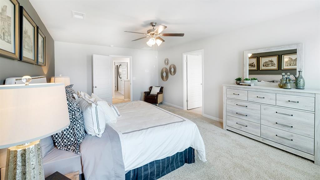 198 Aster Avenue Locust Grove, GA 30248 - Photo 18 of 42 a bedroom with a bed and a chandelier