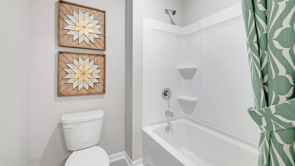 198 Aster Avenue Locust Grove, GA 30248 - Photo 35 of 42 a white toilet sitting next to a bath tub