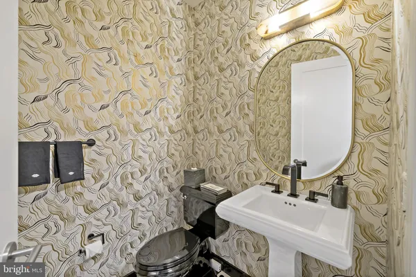 a bathroom with a sink toilet and mirror