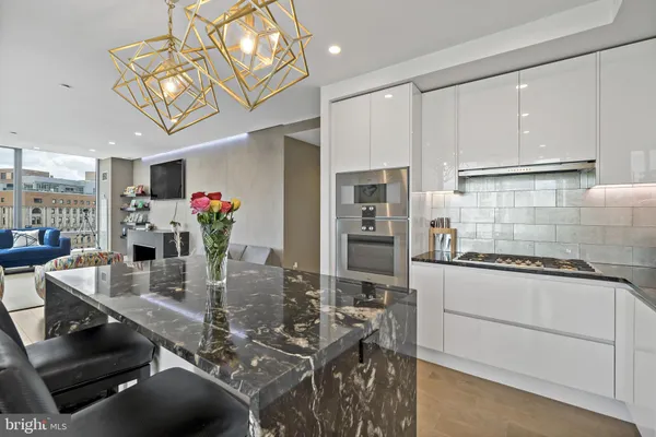 a kitchen with stainless steel appliances granite countertop a stove refrigerator and cabinets