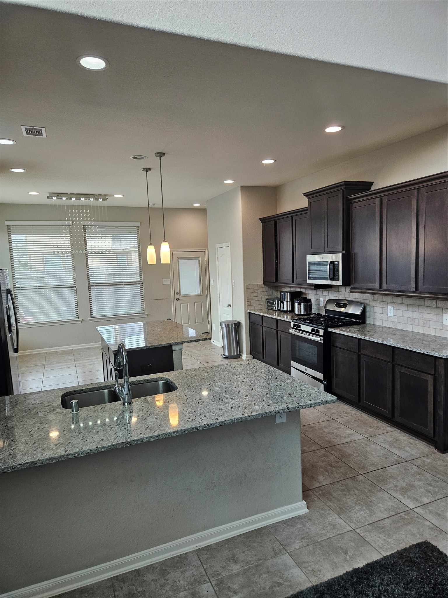 6411 Hunters Trace Lane Baytown, TX 77521 - Photo 8 of 23 Additional Cabinets provides ample Storage. Natural Lighting and Open concept. Oversized island!