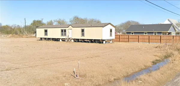 a view of a house with a yard and covered with snow
