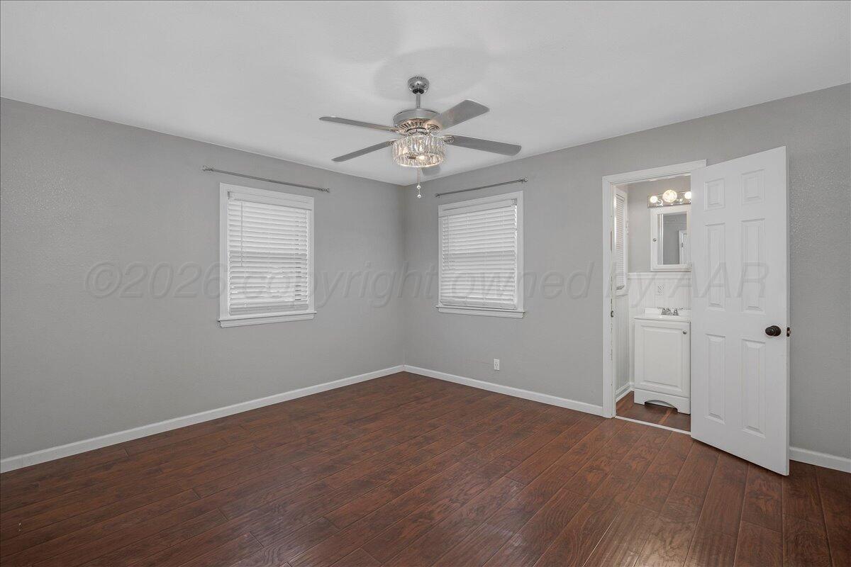 1415 Southwest 34th Avenue Amarillo, TX 79109 - Photo 11 of 22 wooden floor in an empty room with a window