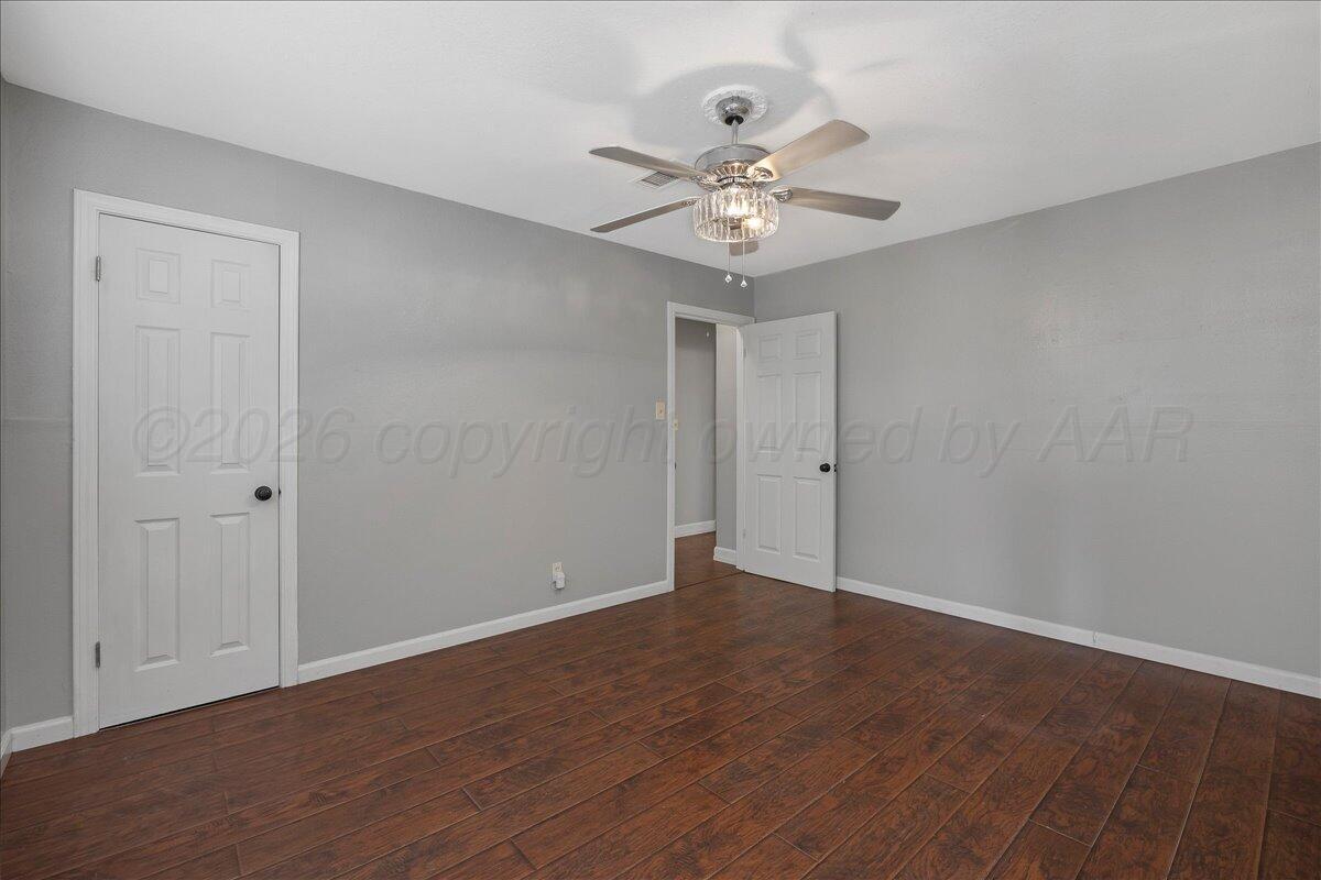 1415 Southwest 34th Avenue Amarillo, TX 79109 - Photo 13 of 22 a view of an empty room with wooden floor